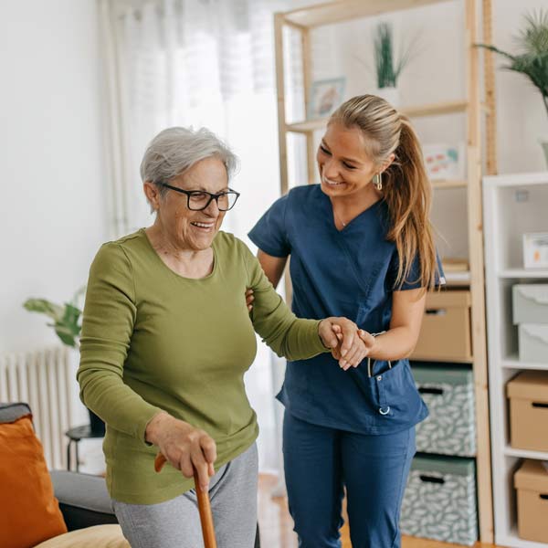 A nurse is helping an old woman in the greater Phoenix area