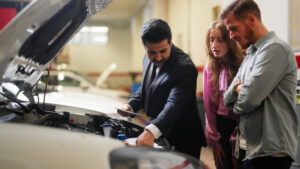 A technician with customer highlighting car insurance plans in the greater Phoenix area