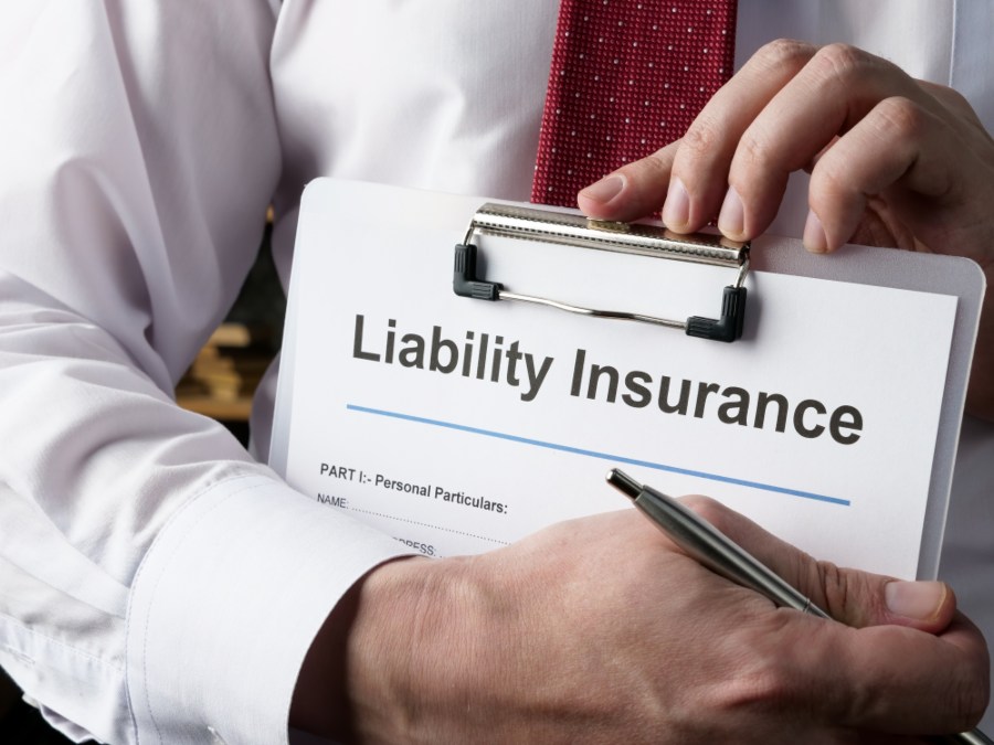 Close-up of a professional holding a clipboard labeled “Liability Insurance” in Glendale & Surprise